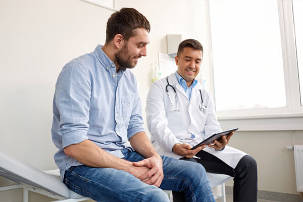 Man speaking to doctor about fertility options.