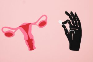 Illustration of a female reproductive organs and a hand holding a sperm.